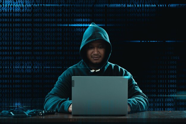 Big financial data theft concept A young hacker is hacking highlyprotected financial data through a computer