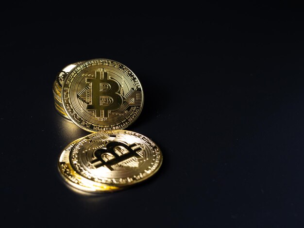 Bitcoin Coins as Cryptocurrency placed on a black background