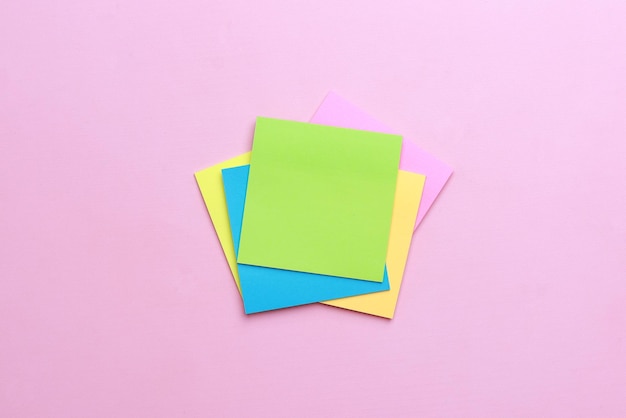 Blank multicolor sticky notes on pink background