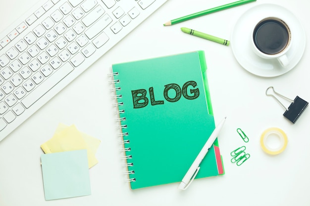blog text on notebook with keyboard and coffee