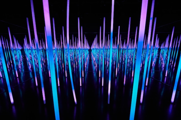 Blue and purple LED light poles in infinity mirror room