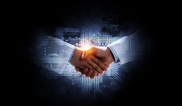 Business handshake by a man and a woman. Mixed media