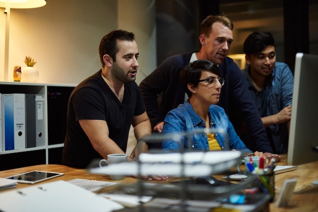 business people computer and collaboration at night for information technology diversity or coding research programming and teamwork for problem solving software development or cybersecurity app