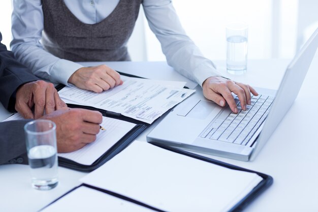 Business people using laptop