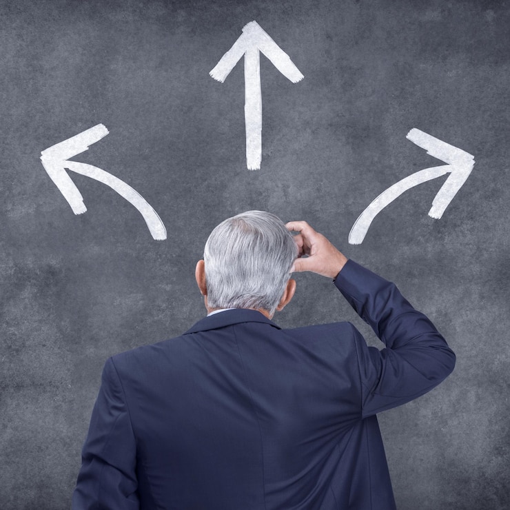Foto businessman decision and arrows with choice for direction selection or pick on a gray studio background rear view of confused man ceo or employee thinking with pointing icons in wonder or thought