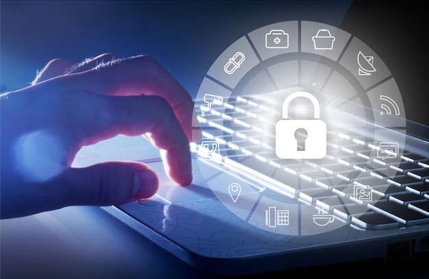 Businessman hand use laptop computer with padlock icon technology,