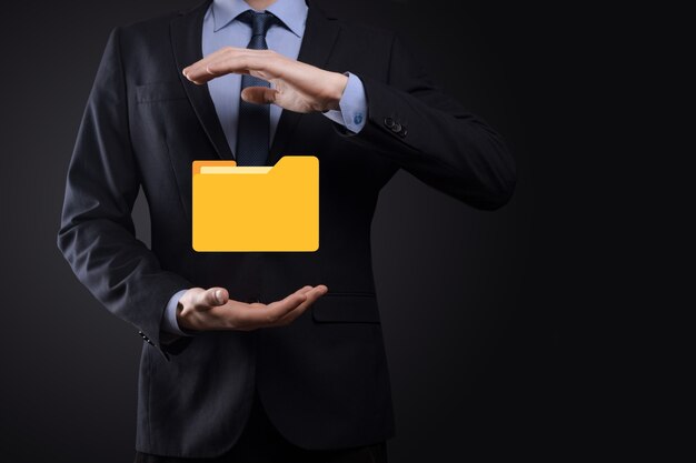 businessman hold folder icon.document management system or dms setup by it consultant with modern computer are searching managing information and corporate files.business processing,