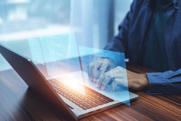 businessman using erp enterprise resource planning document management concept with icons on virtual screen