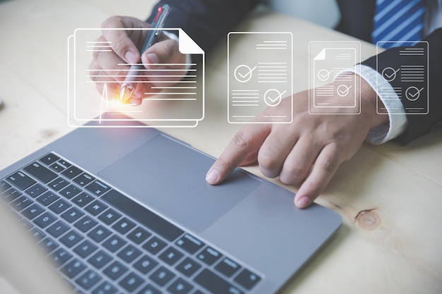 Businessman wearing suits use a pen to sign electronic signature digital documents of paperless with copy space Paperless digital document electronic signature concept