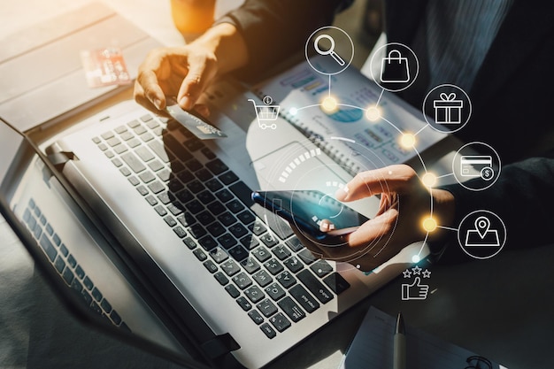 Businessman with mobile smartphone paying online and shopping on virtual interface