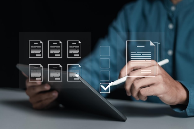 businessman working on tablet to document management online for checklist and clipboard task management filling survey form online answer questions of test survey form concept