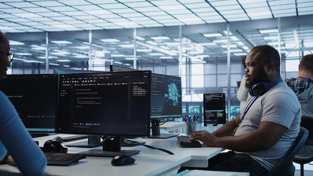 cheerful it specialist monitoring high tech supercomputers using tablet