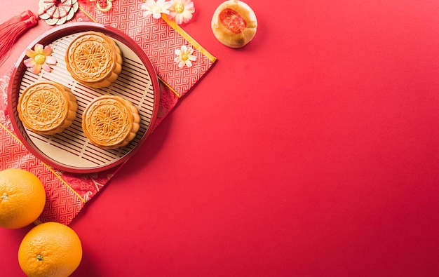 Chinese MidAutumn Festival concept made from mooncakes tea and plum blossom Chinese characters FU in the article refer to fortune good luck wealth money flow