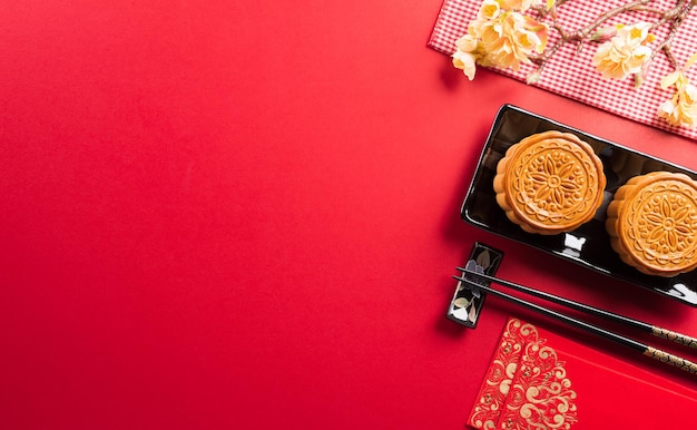 Chinese MidAutumn Festival concept made from mooncakes tea and plum blossom Chinese characters FU in the article refer to fortune good luck wealth money flow