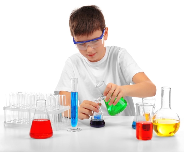 Clever little boy doing a chemical experiments isolated on white
