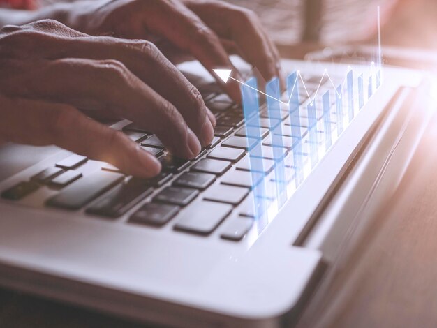 close up hand businessman touch enter on laptop keyboard show graph stock market bar chart grow up to target business finance concept businessman analysis and success graph stocks grow set goals