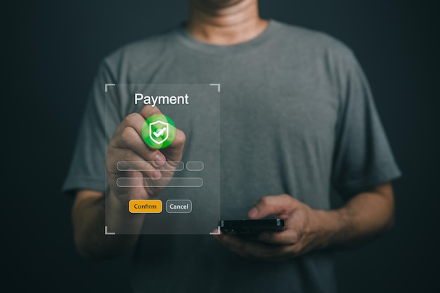Close up Hand Man Using Smartphone to Complete Online Payment with Secure Payment Confirmation and Cancellation Options in Dark Background