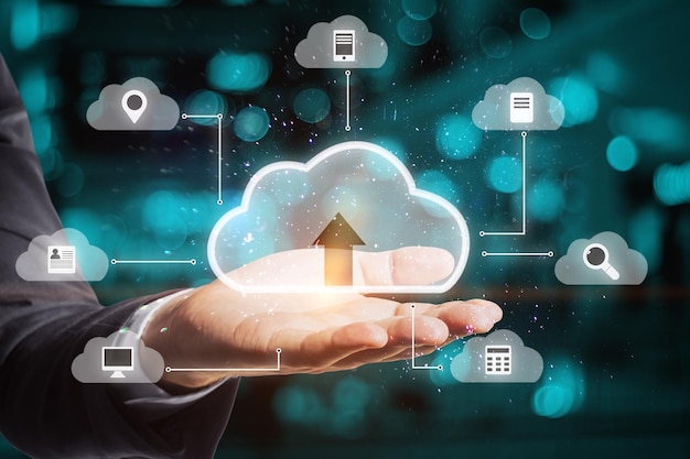 Close up of businessman hand holding abstract digital cloud on blurry server room background Cloud computing database and technology concept