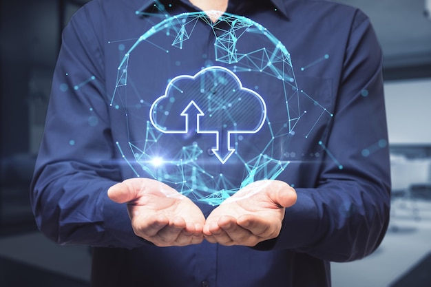 close up of businessman hand holding abstract glowing polygonal sphere with cloud and arrows on blurry office interior background cloud computing and database concept double exposure