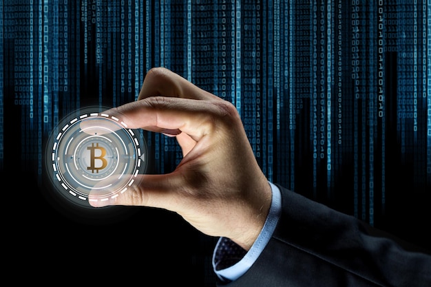 close up of businessman hand with bitcoin hologram