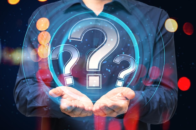 close up of businessman hands holding glowing round question mark hologram on blurry bokeh background faq and customer service concept double exposure