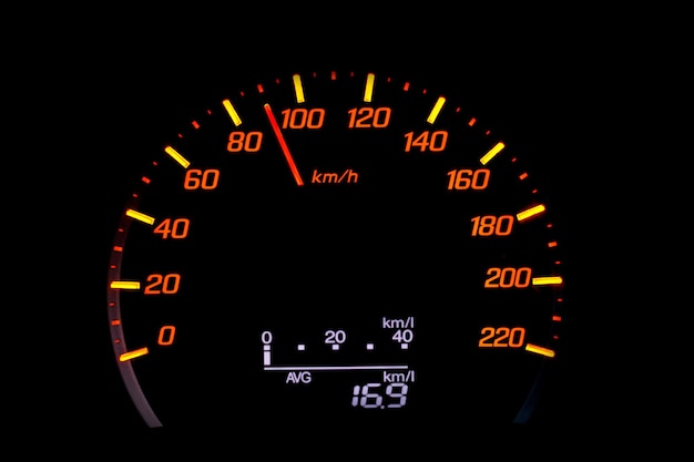 close up of car speedometer with the needle pointing at  90 kmh on black blackground