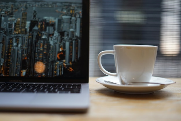 Close-up of coffee cup by lap on table