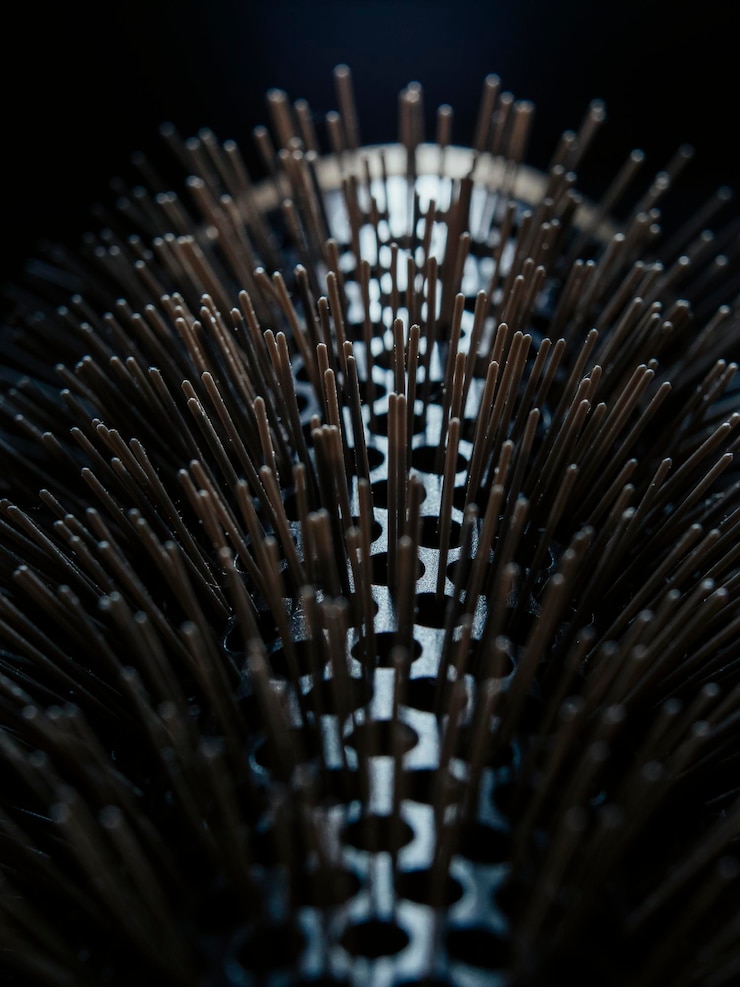 Bild close up of hairbrush bristles poking out of holes