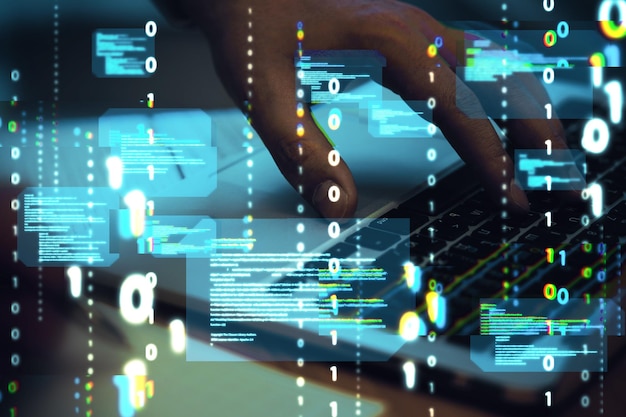 Close up of hands using computer keyboard with abstract coding binary code hologram on blurry background Artificial intelligence and development concept Double exposure