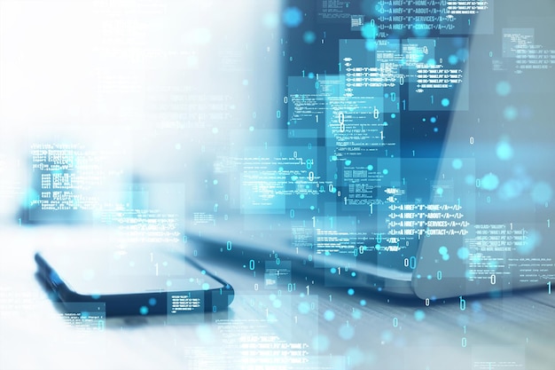 Close up of laptop and cellphone with creative binary coding hologram on blurry background Software programming code