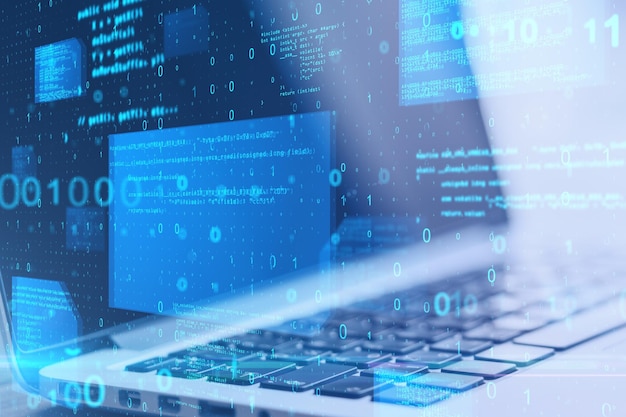 Close up of laptop computer at desktop with abstract glowing blue coding background Binary code technology data and internet concept Double exposure