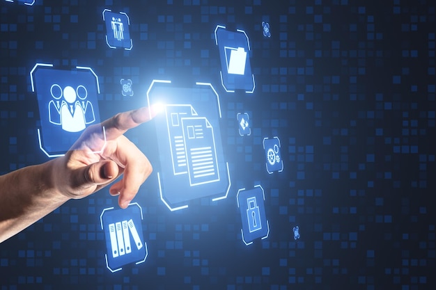 Close up of male hand pointing at glowing blue icons on blurry background Online management and remote work concept