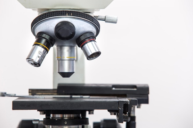 Close-up of microscope against white background