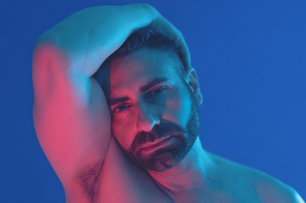 close-up portrait of mid adult man against blue background