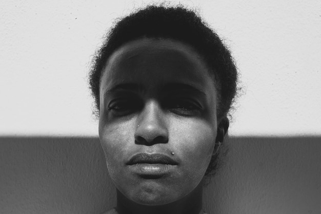 close-up portrait of mid adult woman by wall