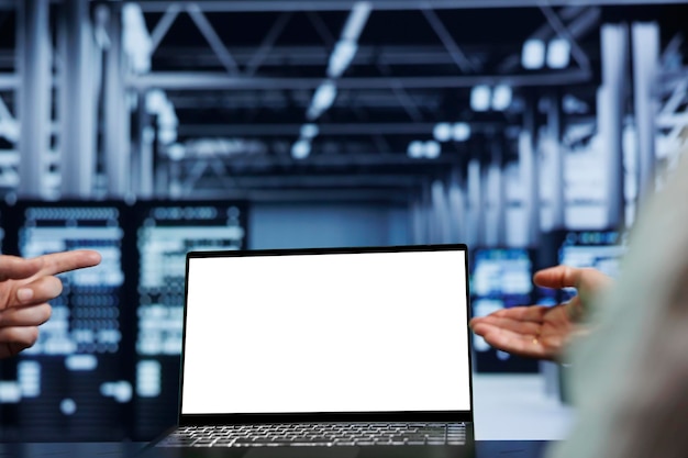 Close up shot of mock up laptop used by competent technician in data center using server rigs to deliver massive computing power, control network resources, process and store datasets