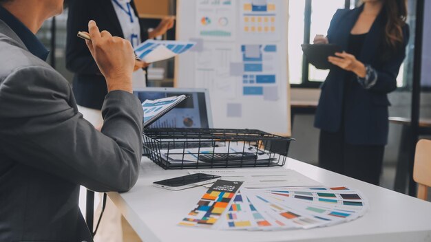 Close up ux developer and ui designer use augmented reality brainstorming about mobile app interface wireframe design on desk at modern officeCreative digital development agency