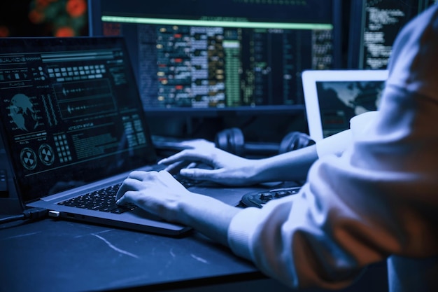 Close up view of female hacker hands typing on keyboard