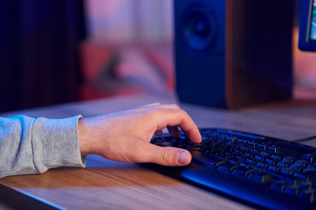 Close up view of man's hand typing on the PC's keyboard