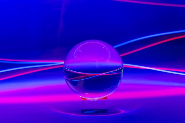 Closeup of a lens ball with colorful lights with long exposure against a blue background
