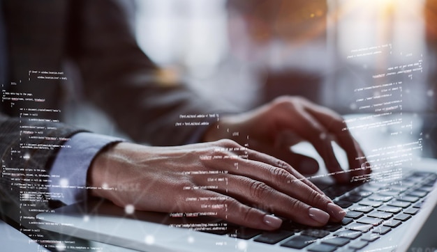 Closeup of male hands using laptop at office