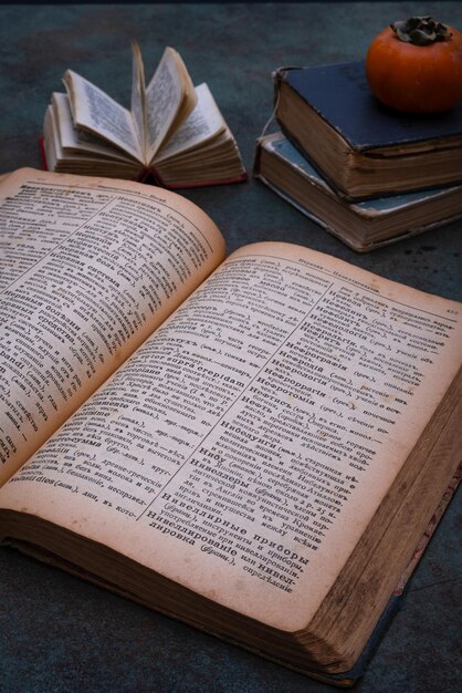 Closeup of several old dictionaries against a dark background Selective focus