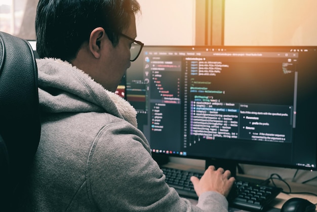 Coder programmers working in office Programmer analyst writing code Coder working from home with work on screen computer for learning and developing programs digital coding scripts java language