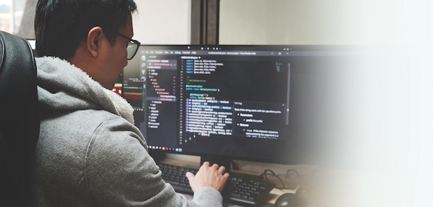 Coder programmers working in office Programmer analyst writing code Coder working from home with work on screen computer for learning and developing programs digital coding scripts java language
