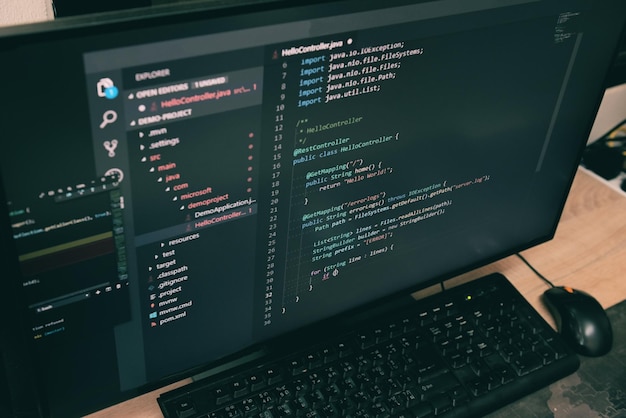 Coder programmers working in office Programmer analyst writing code coding program on screen computer for learning and developing programs digital coding scripts java language
