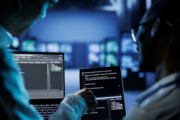 Colleagues code on tablet in data center