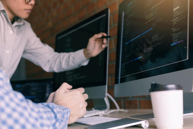 Colleagues coding in office
