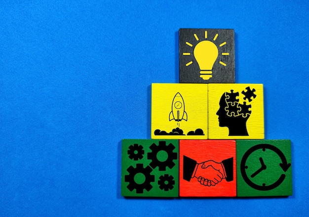 Colored wooden with targeted business icons and the concept of success
