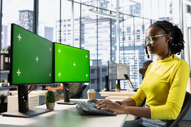 Company employee in workspace doing tasks on mockup PC