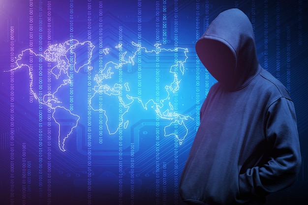 Computer hacker silhouette of hooded man with binary data and network security terms